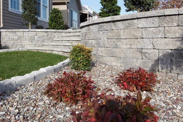 hardscape retaining wall and stone flower bed